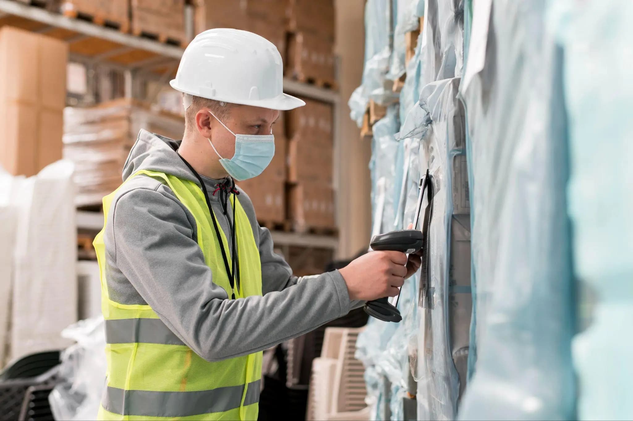 Warehouse worker scanning packaged goods in storage